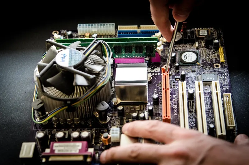 Computer repair workbench with tools and exposed hardware