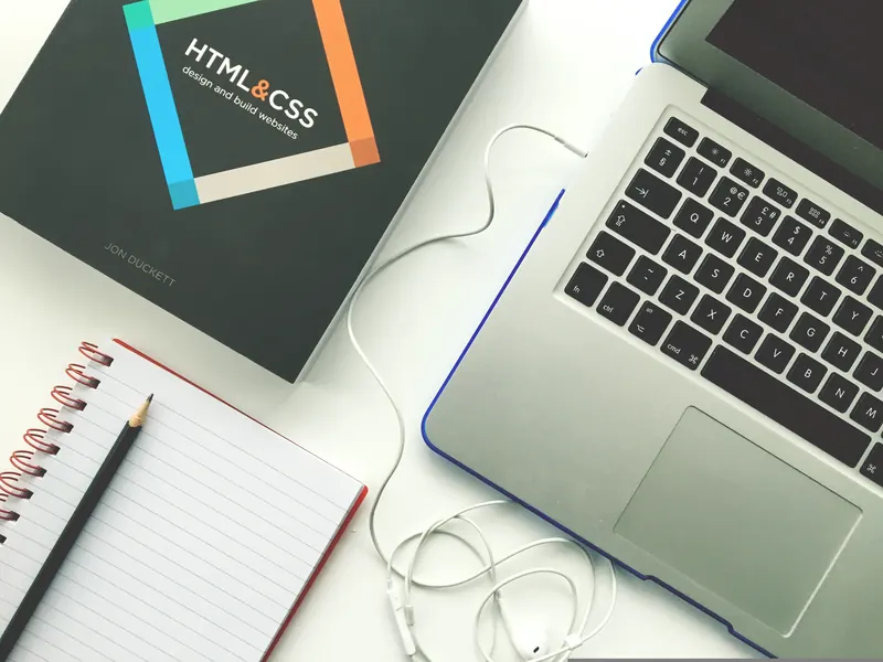 Laptop showing web design and HTML code